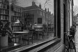 An empty neighbourhood library viewed through rain-speckled glass — AI-generated editorial image